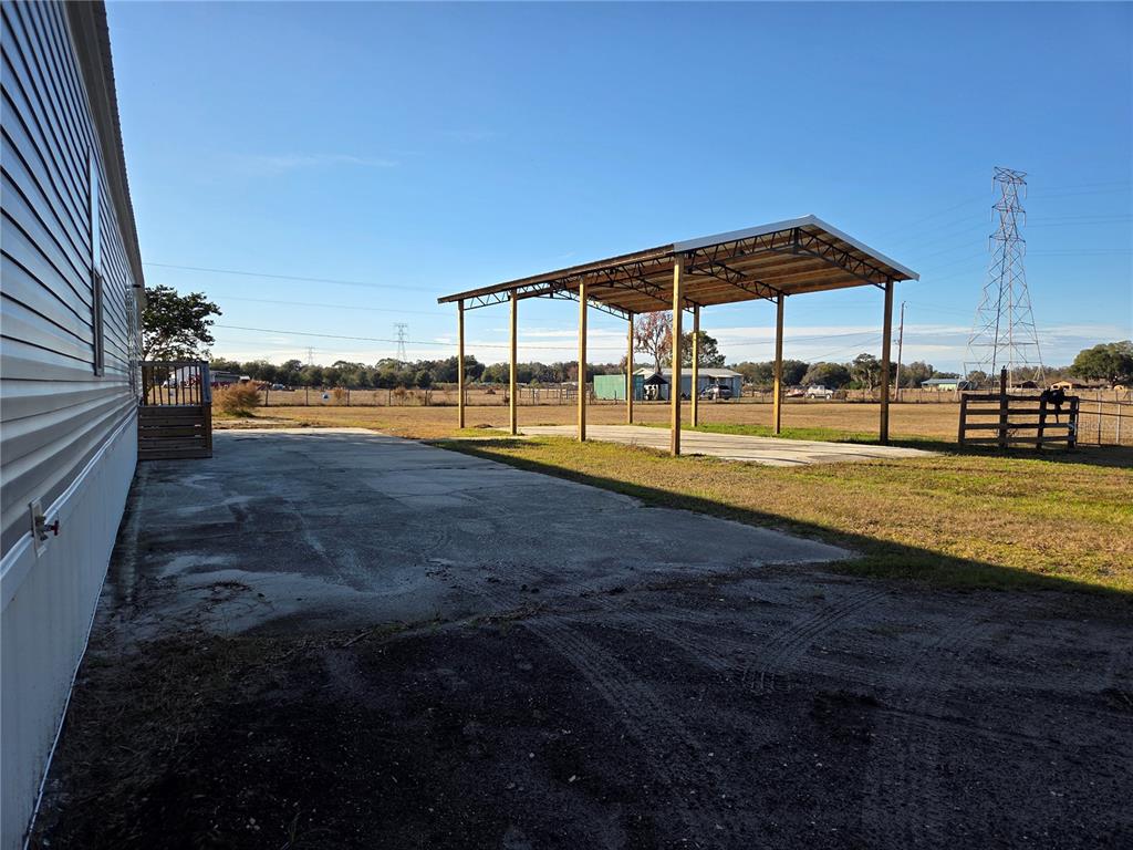 4901 North Vaughn Road Plant City, FL 33565 - Photo 30 of 31 a view of swimming pool with lawn chairs under an umbrella