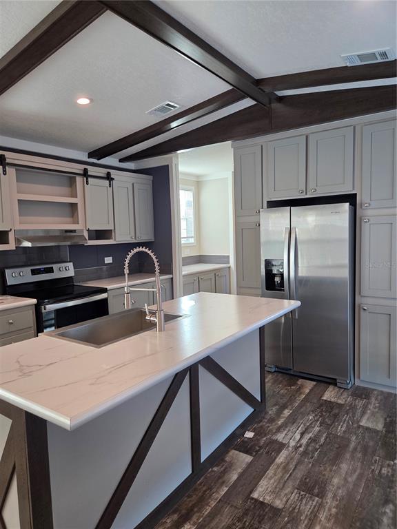 4901 North Vaughn Road Plant City, FL 33565 - Photo 7 of 31 a kitchen with stainless steel appliances a sink stove and refrigerator