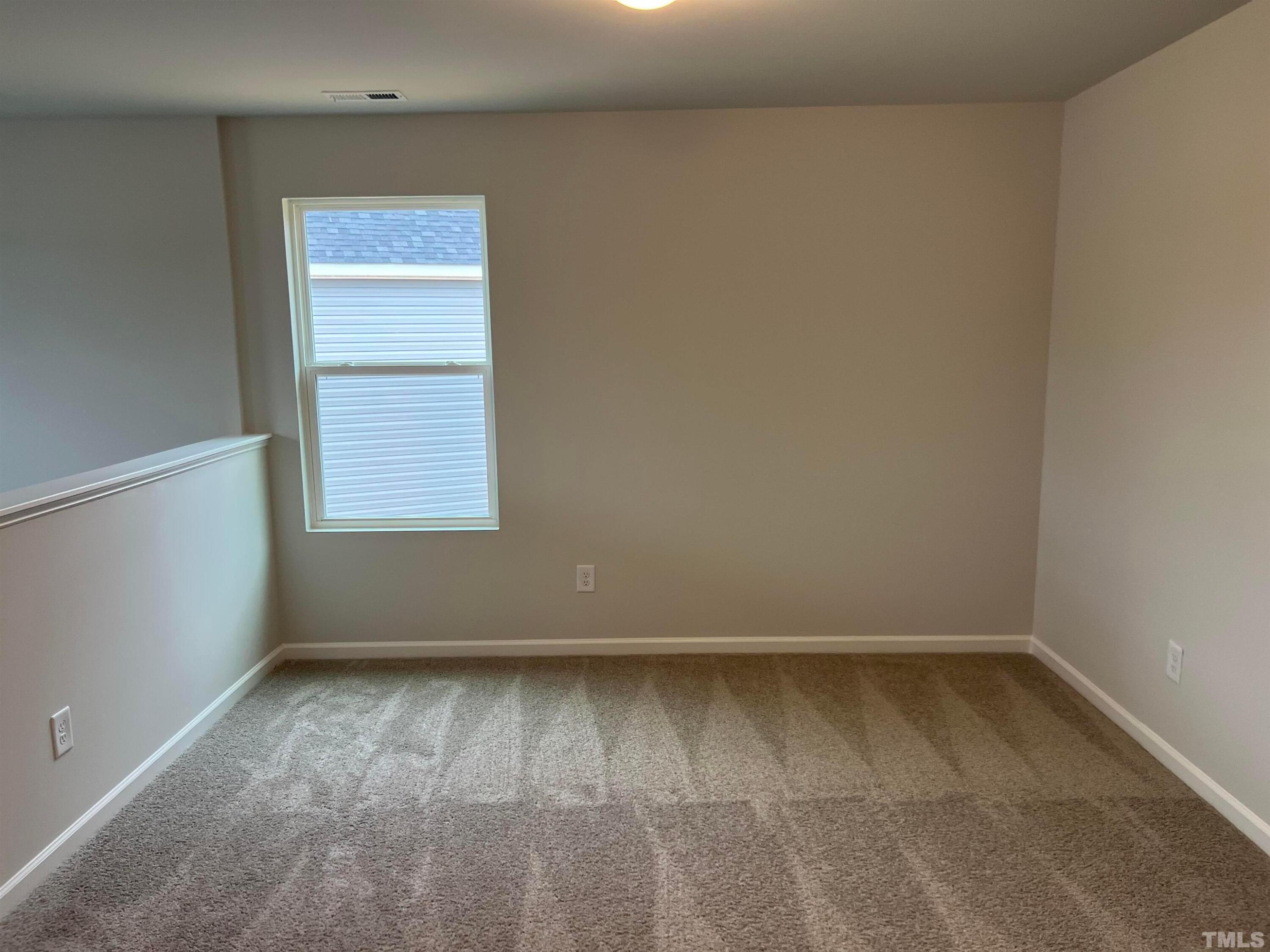 179 Maple Tree Lane Clayton, NC 27527 - Photo 11 of 18 an empty room with a window