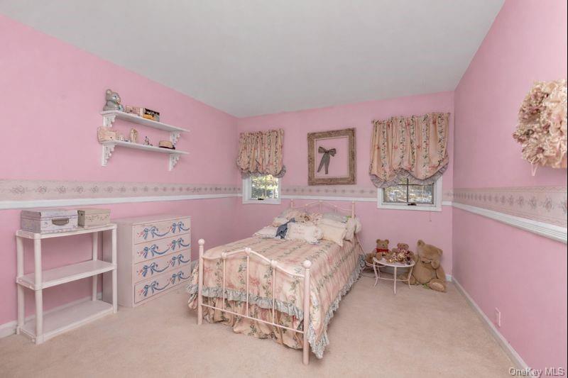 39 Fleets Cove Road Huntington, NY 11743 - Photo 18 of 20 Bedroom with light colored carpet and baseboards