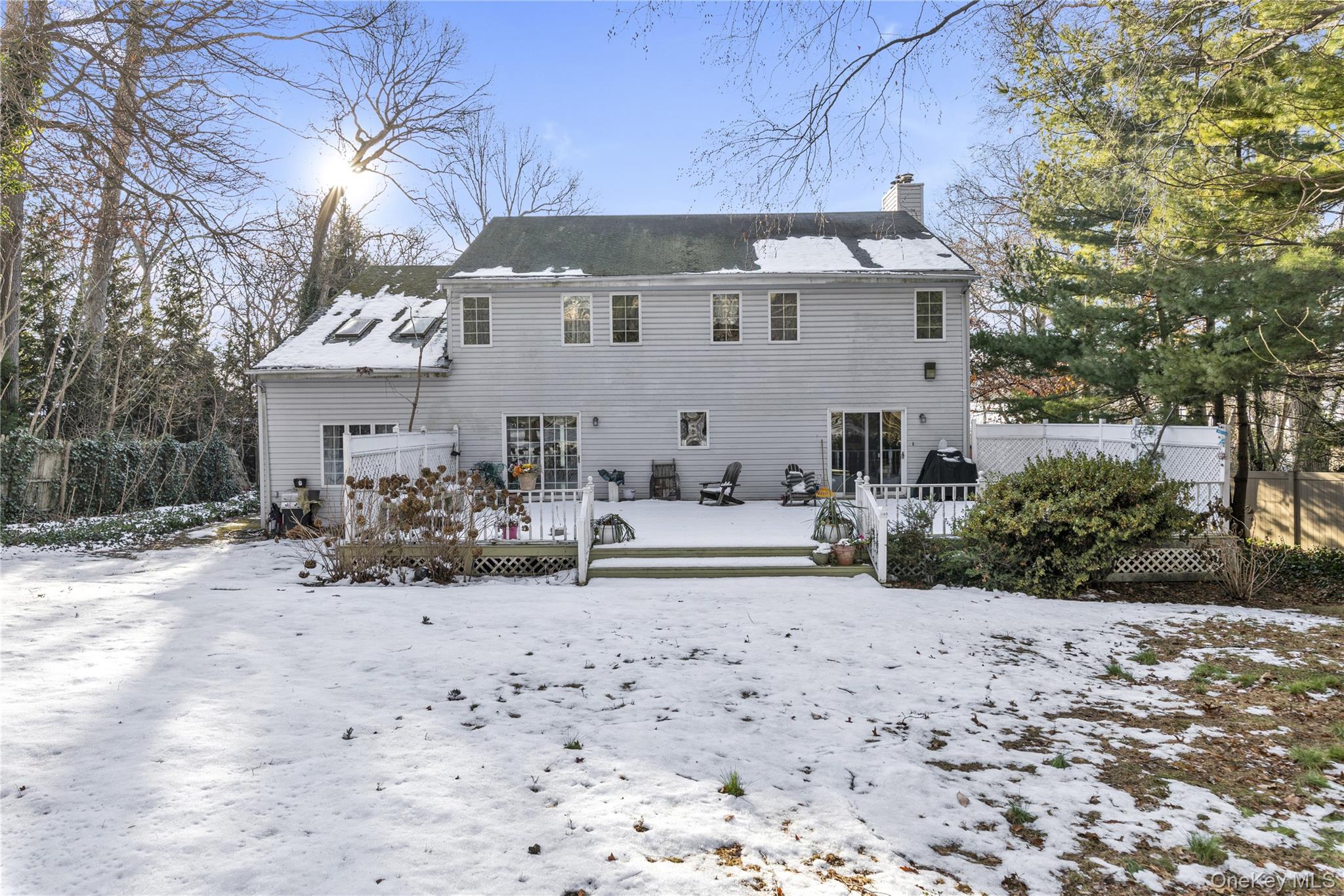 39 Fleets Cove Road Huntington, NY 11743 - Photo 19 of 20 Snow covered rear of property featuring a chimney and a wooden deck