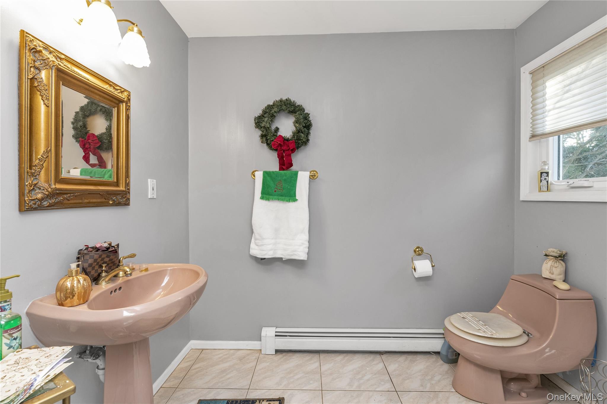 39 Fleets Cove Road Huntington, NY 11743 - Photo 7 of 20 Half bath featuring a baseboard radiator and light tile patterned floors