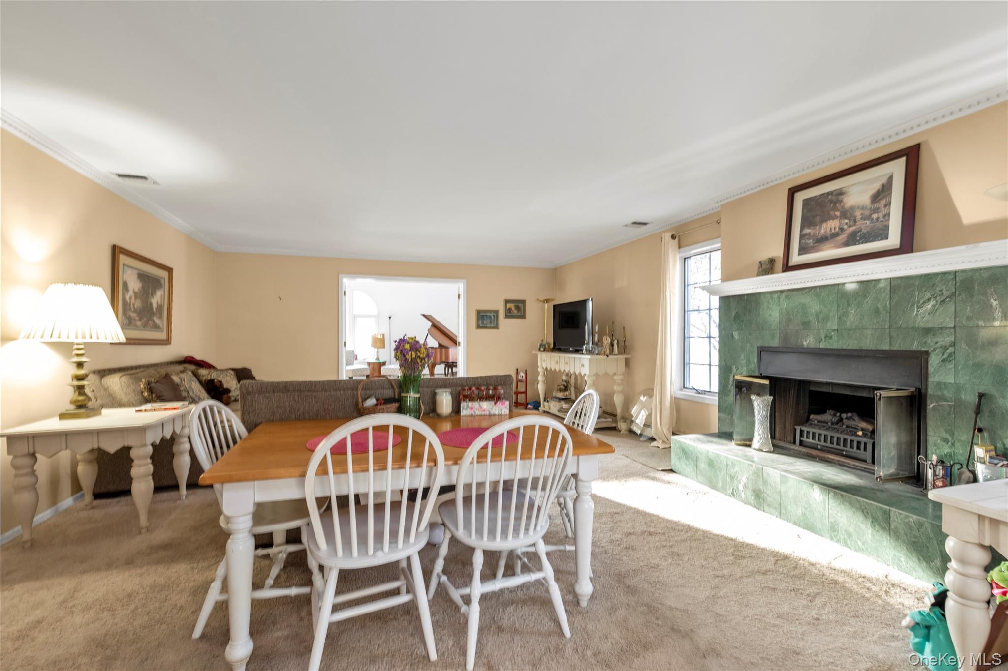 39 Fleets Cove Road Huntington, NY 11743 - Photo 9 of 20 Carpeted dining space with ornamental molding and a premium fireplace