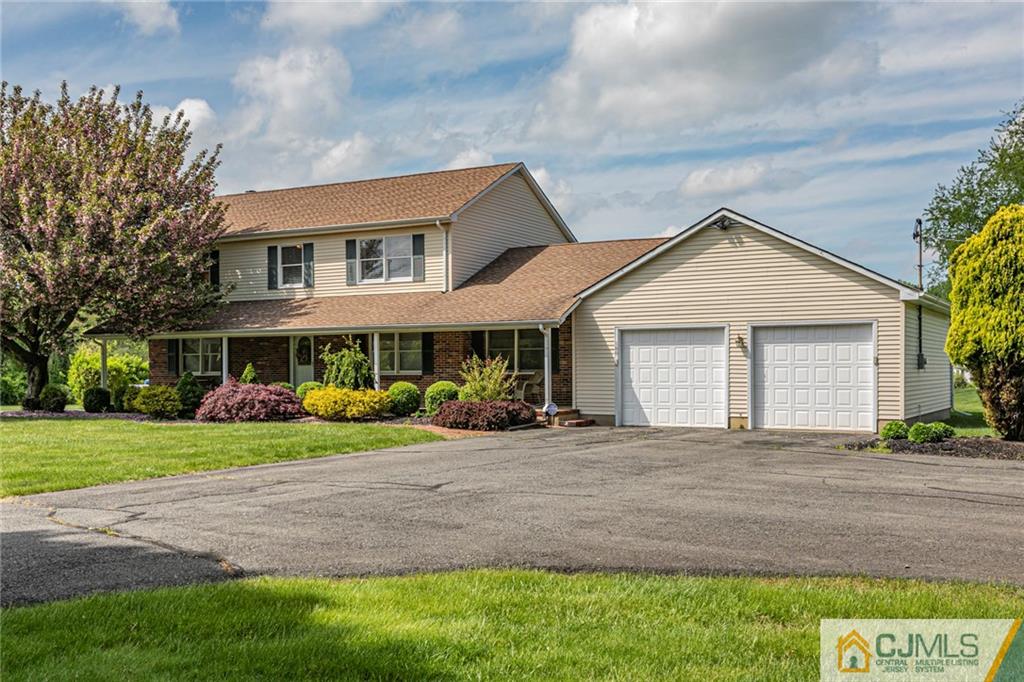 180 Friendship Road, Unit A Cranbury, NJ 08512 - Photo 3 of 42 a front view of a house with a yard and porch
