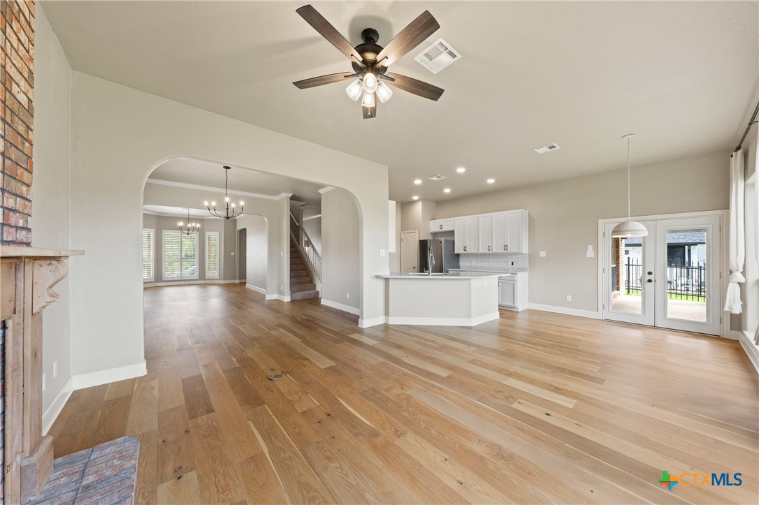 4512 Sunflower Lane Temple, TX 76502 - Photo 13 of 48 a view of an empty room and kitchen with wooden floor