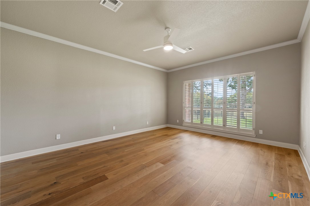 4512 Sunflower Lane Temple, TX 76502 - Photo 17 of 48 a view of an empty room with wooden floor and a window