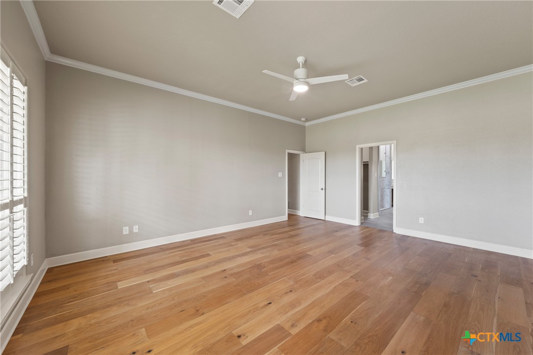 4512 Sunflower Lane Temple, TX 76502 - Photo 18 of 48 an empty room with wooden floor and windows