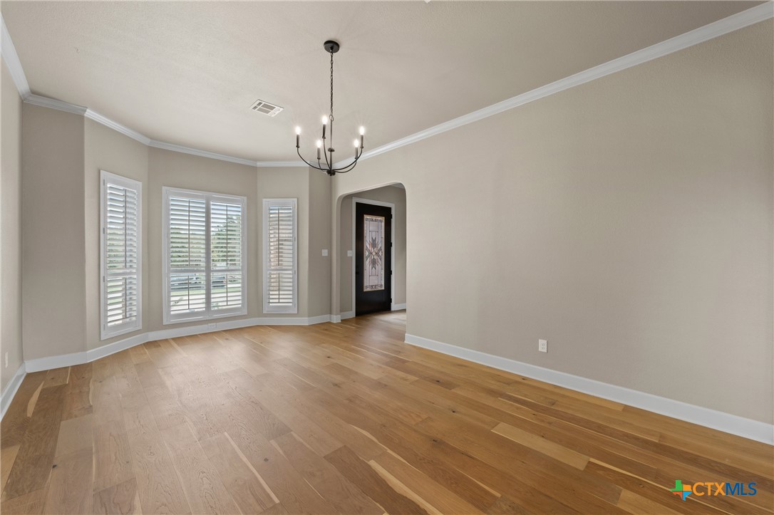 4512 Sunflower Lane Temple, TX 76502 - Photo 6 of 48 a view of empty room with wooden floor and large window
