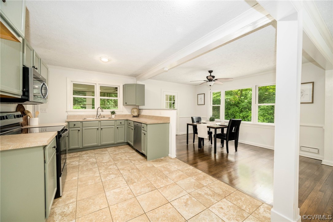 11824 Boyd Road Chester, VA 23831 - Photo 13 of 36 a kitchen with a table chairs sink and cabinets