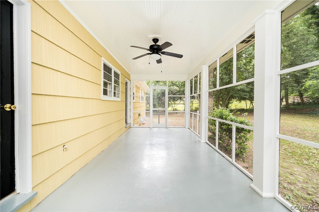 11824 Boyd Road Chester, VA 23831 - Photo 17 of 36 a view of a porch with wooden floor and a ceiling fan