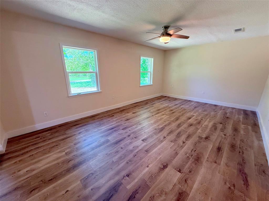 45 County Road 1197 Yantis, TX 75497 - Photo 12 of 26 wooden floor in an empty room with a window