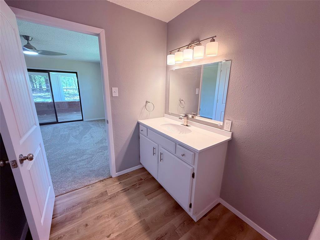 45 County Road 1197 Yantis, TX 75497 - Photo 16 of 26 a bathroom with a sink a mirror and a toilet