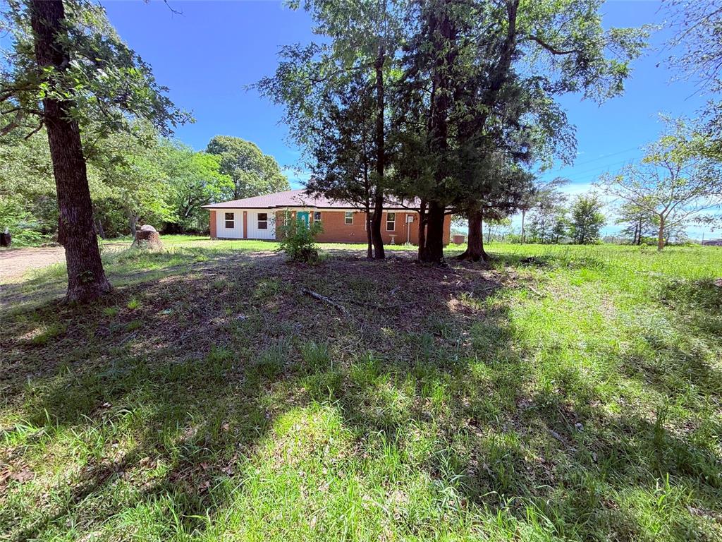 45 County Road 1197 Yantis, TX 75497 - Photo 2 of 26 a view of a house with a tree in the yard