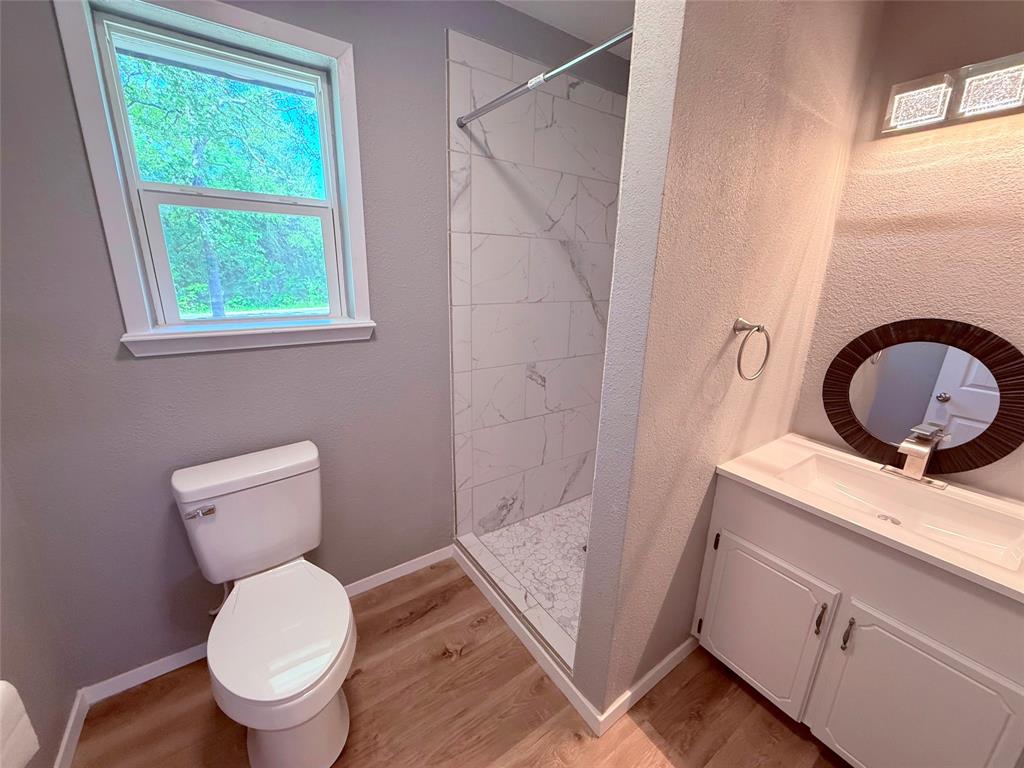 45 County Road 1197 Yantis, TX 75497 - Photo 21 of 26 a bathroom with a toilet sink and a window