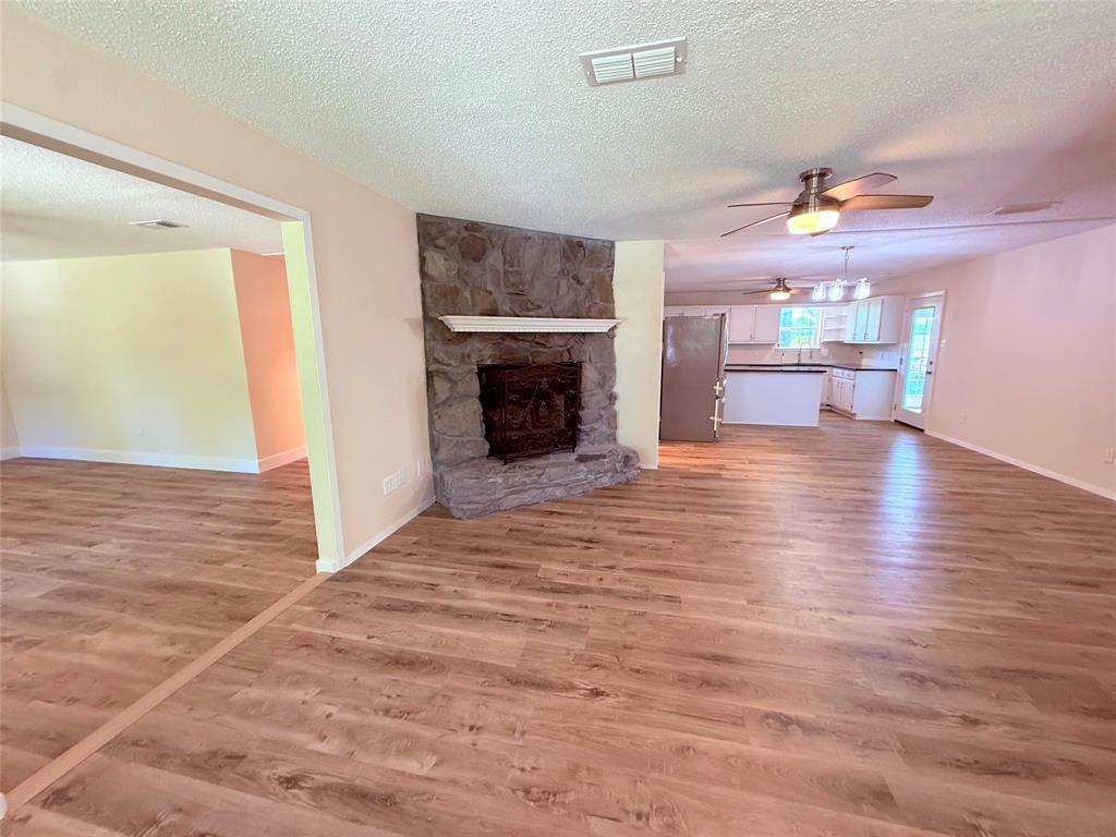 45 County Road 1197 Yantis, TX 75497 - Photo 4 of 26 a view of a kitchen with a sink a fireplace and a window