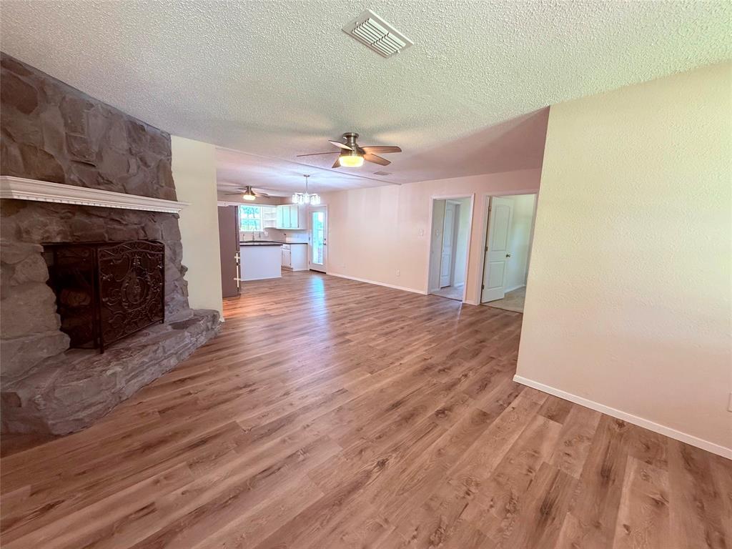 45 County Road 1197 Yantis, TX 75497 - Photo 5 of 26 a view of a livingroom with a fireplace and wooden floor
