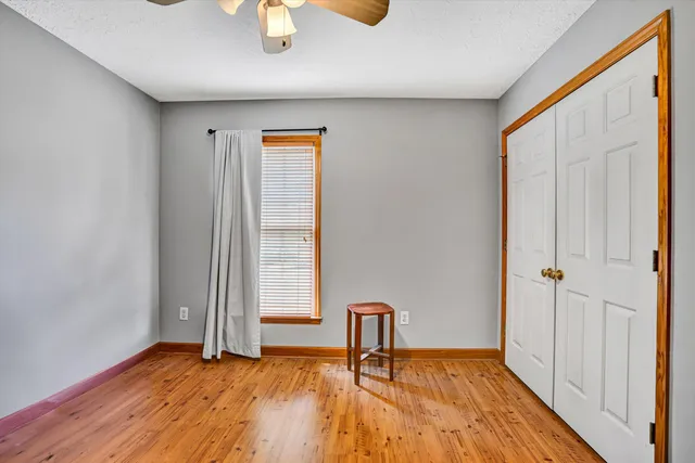 a view of a room with wooden floor and bench