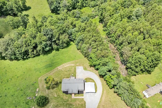 an aerial view of residential house with outdoor space and swimming pool