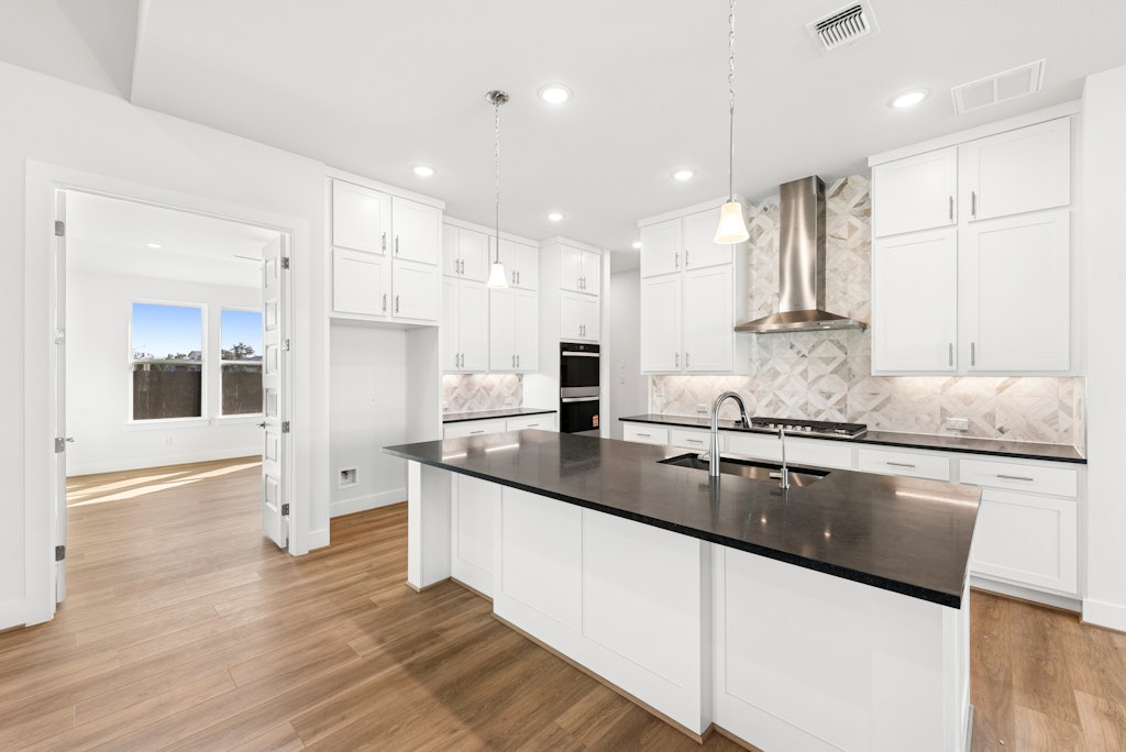 3332 Emerald Lake Path Georgetown, TX 78628 - Photo 15 of 35 a large kitchen with granite countertop a large counter top appliances and cabinets