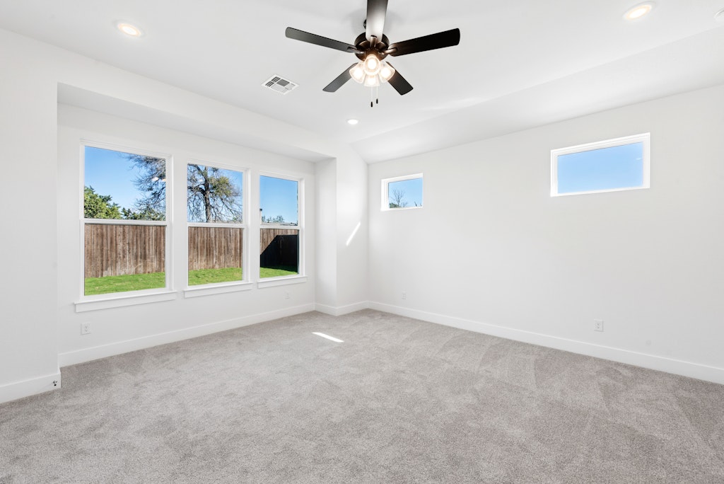3332 Emerald Lake Path Georgetown, TX 78628 - Photo 16 of 35 an empty room with windows and fan