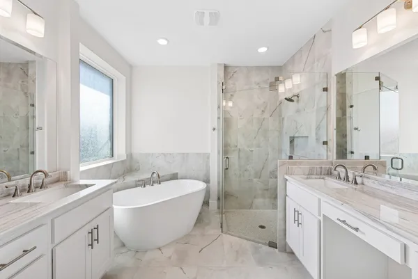 a spacious bathroom with a double vanity sink mirror double and bathtub