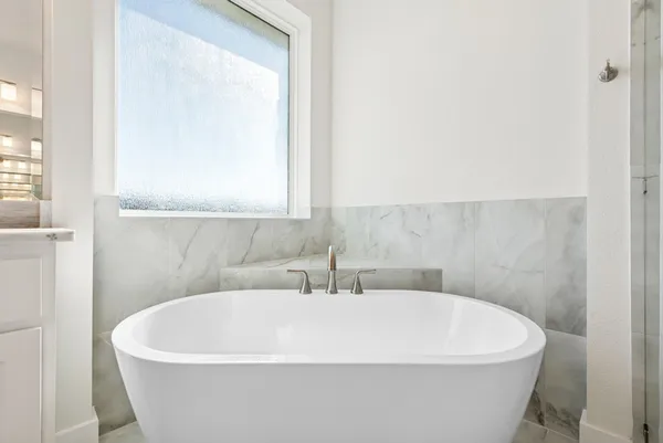 a white bath tub sitting in a bathroom