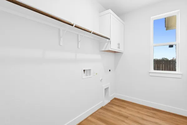 a view of a room with wooden floor and cabinet