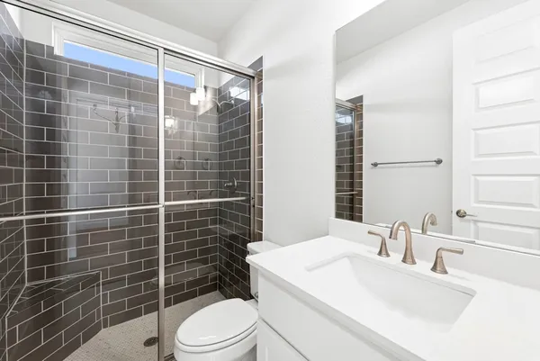 a bathroom with a sink toilet and shower