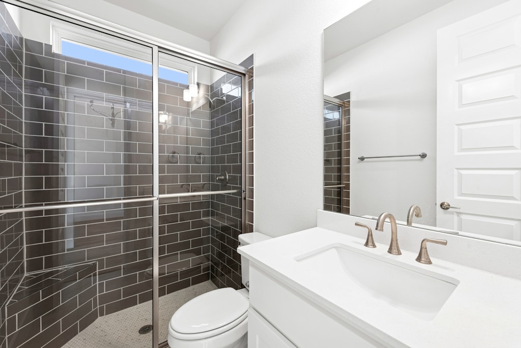 3332 Emerald Lake Path Georgetown, TX 78628 - Photo 30 of 35 a bathroom with a sink toilet and shower
