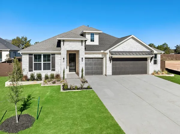 a front view of a house with a yard and porch