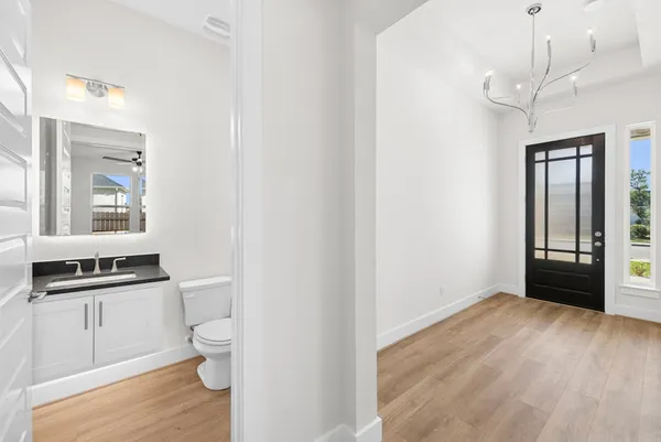 a view of a kitchen with a sink wooden floor and a window