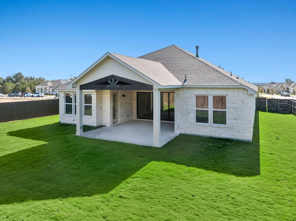 3332 Emerald Lake Path Georgetown, TX 78628 - Photo 33 of 35 a front view of a house with a garden and yard