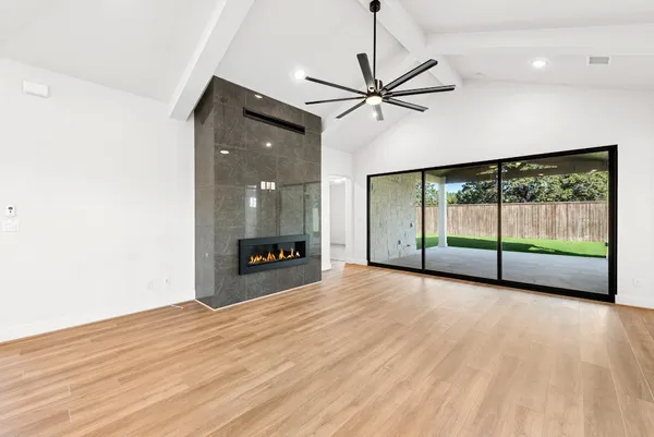 a view of room with wooden floor fan and windows