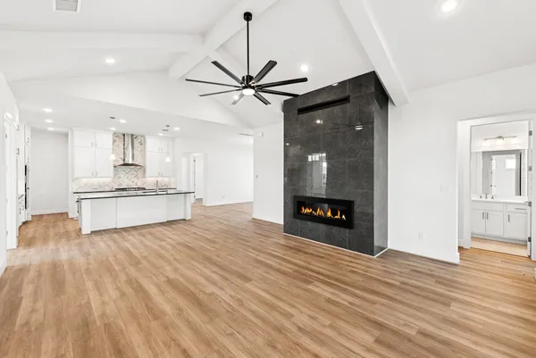 a view of a kitchen with wooden floor and a kitchen