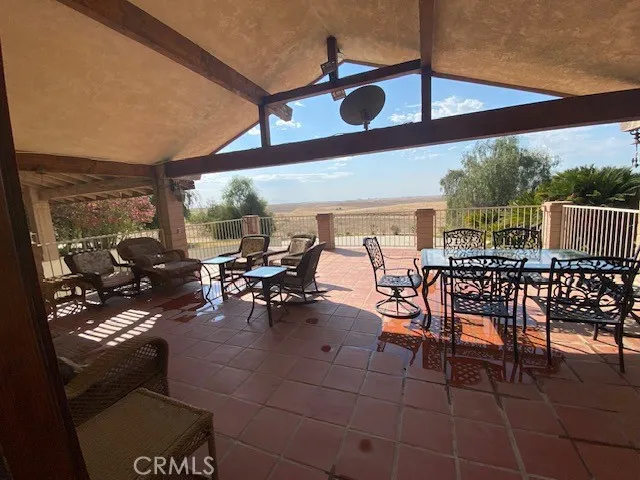 a view of a patio with table and chairs and potted plants
