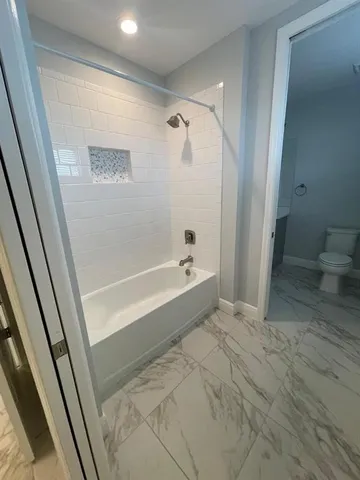 an empty room with workspace and stairs