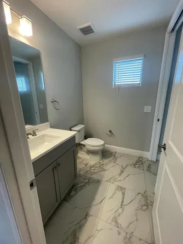 a utility room with cabinets washer and dryer
