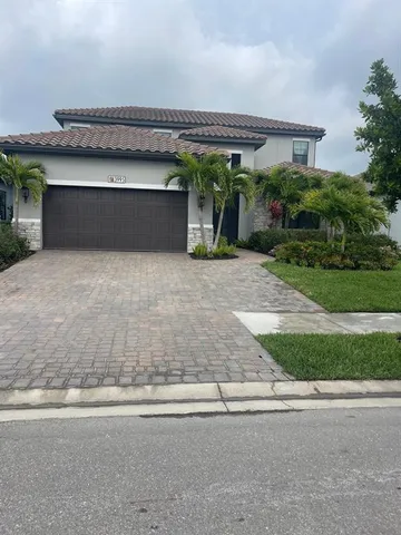 a view of a backyard with plants and outdoor seating