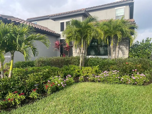 a view of a garden with a building in the background