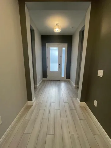 a view of a room with wooden floor and window