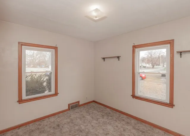 a view of an empty room with a window