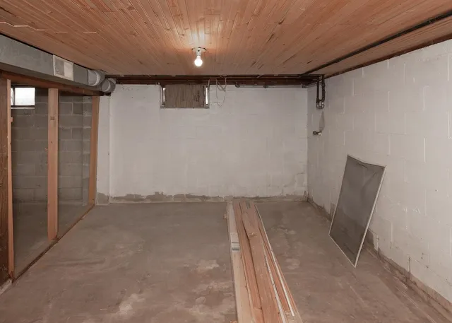 a view of a room with wooden floor and bench