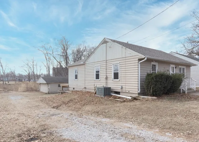 a view of a house with a yard and sitting area