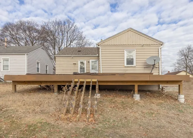 a backyard of a house with table and chairs