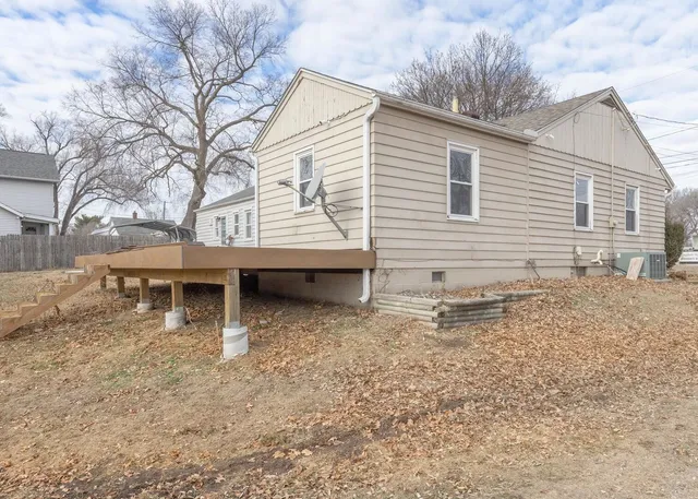 a view of a house with a yard and sitting area