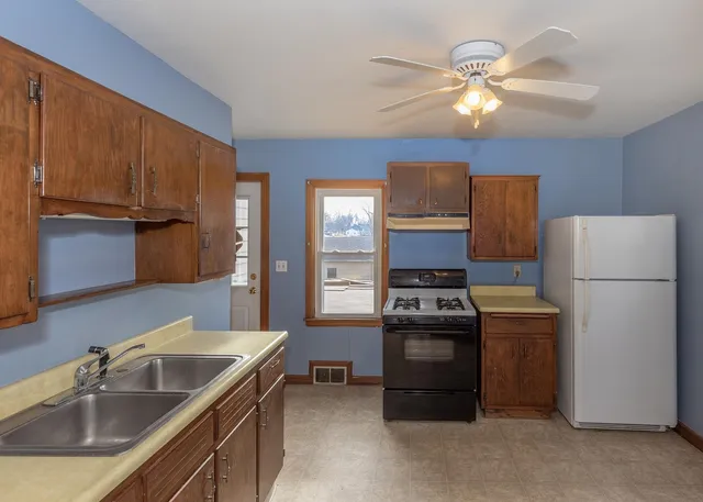 a kitchen with a sink appliances and cabinets