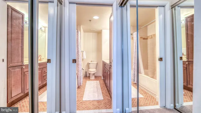 a view of a bathroom from a corridor