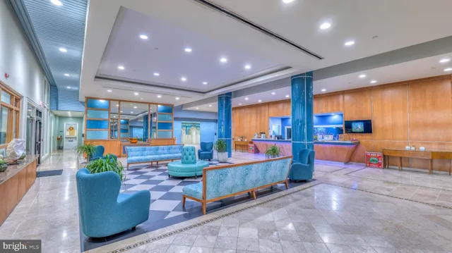 a lobby with furniture and a potted plant