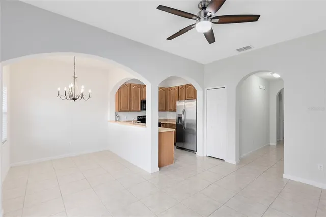 a view of a kitchen with refrigerator and cabinet