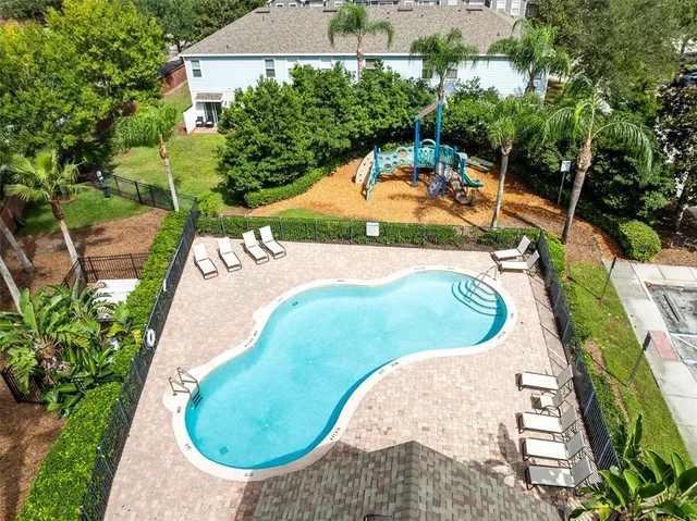 an aerial view of residential houses with outdoor space and river